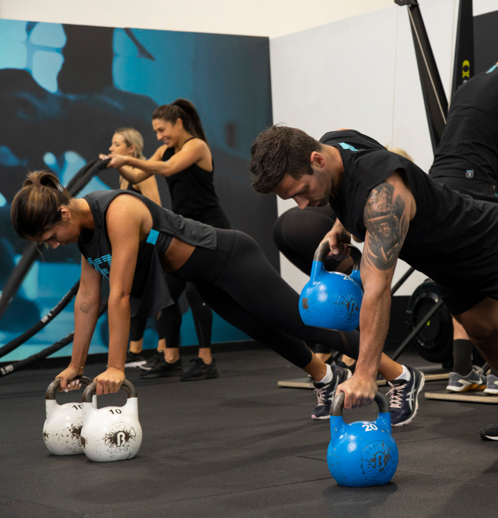 Two people working out with kettlebells